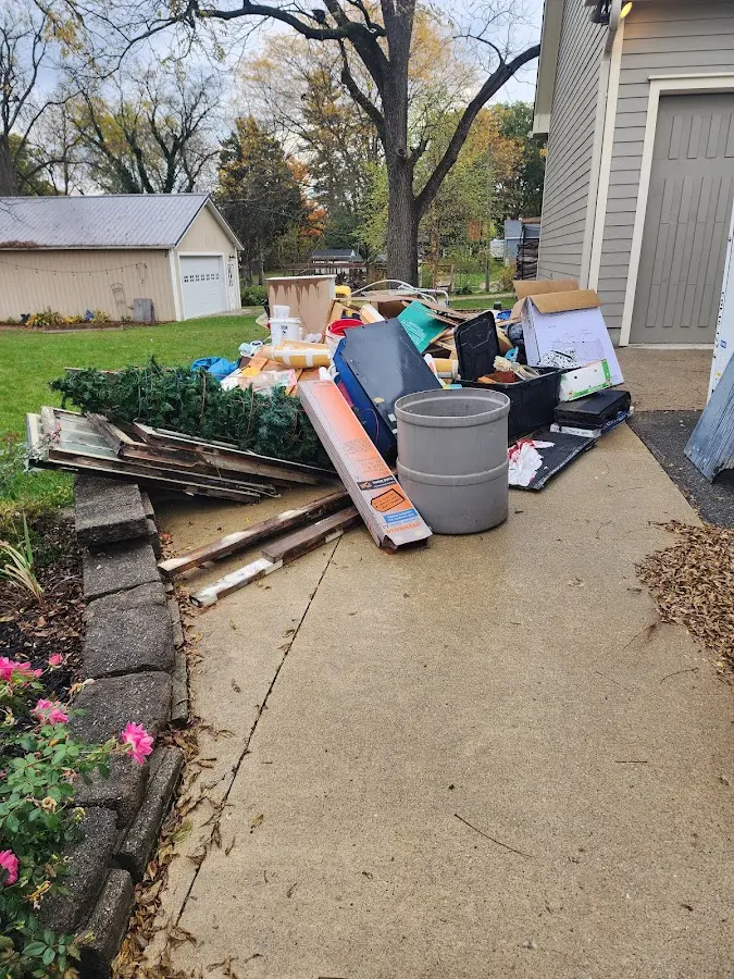 Dumpster being loaded with debris for 12 Yard Dumpster Rental in Carlisle